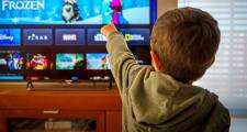 Child pointing at tv screen