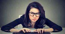Woman typing keyboard angry
