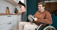 Man in wheechair drying dishes
