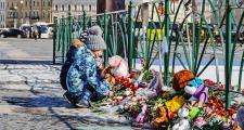 Child lays memorial flowers