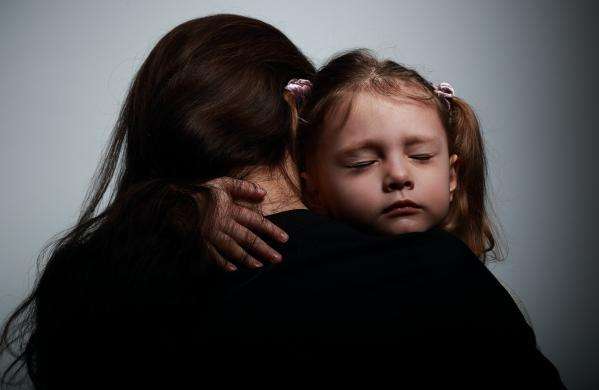 Young child being comforted by a social worker