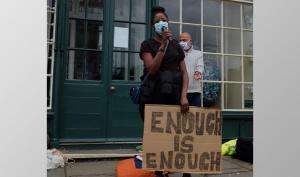 Amanda Takavarasha holding enough is enough placard