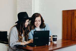 Teenagers looking at a laptop